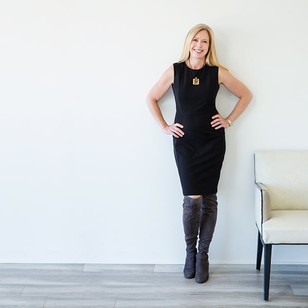 In the Press With Bridget Grimes, CFP® Headshot 2 With Gold Necklace and Chair