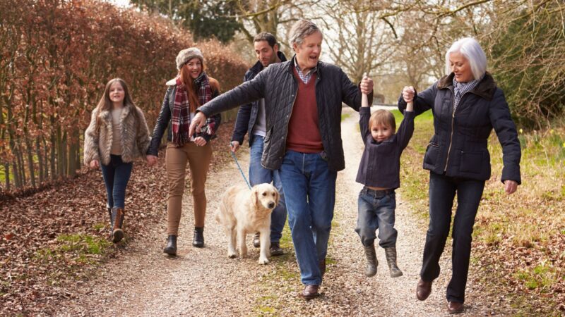 Multigenerations in a family on a walk in the fall