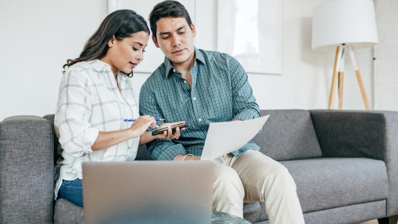 Couple looking over financial paperwork and planning for their taxes