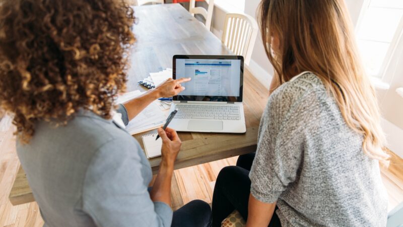 Two women looking over financial documents and making retirement plans