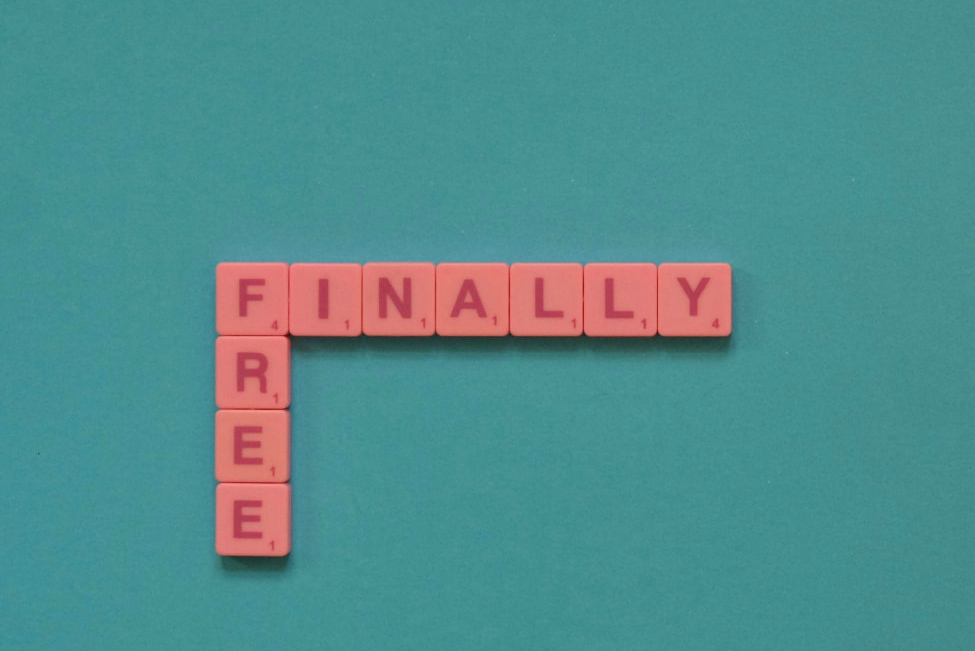 Scrabble board that says "Finally Free"