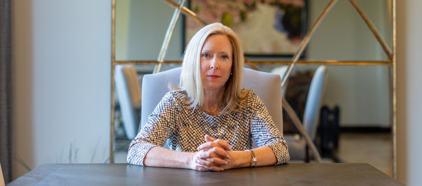 Financial Planner Bridget Venus Grimes, sitting at a table ready to serve women professionals