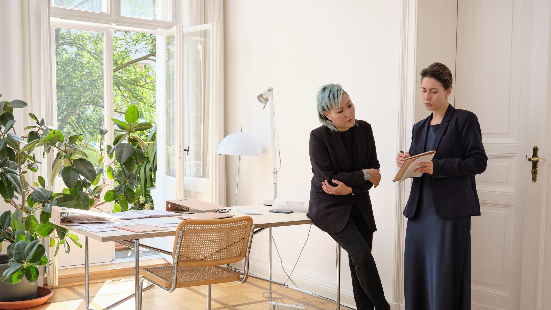 Two female breadwinners looking at a document