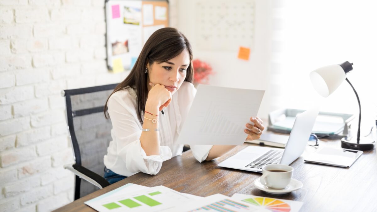 Woman looking at her financial documents at her desk